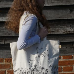 linen shopping bag with hand drawn images of alpacas in tall grass