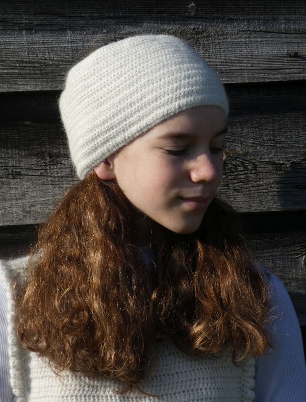white crochet headband worn by girl with long brown hair