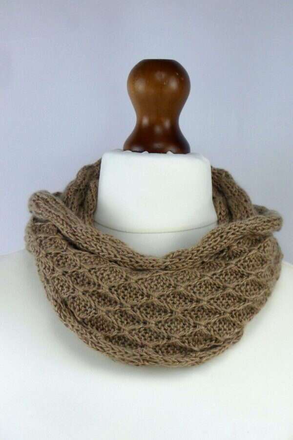 cappuccino cowl wrapped around the neck of a dress dummy.