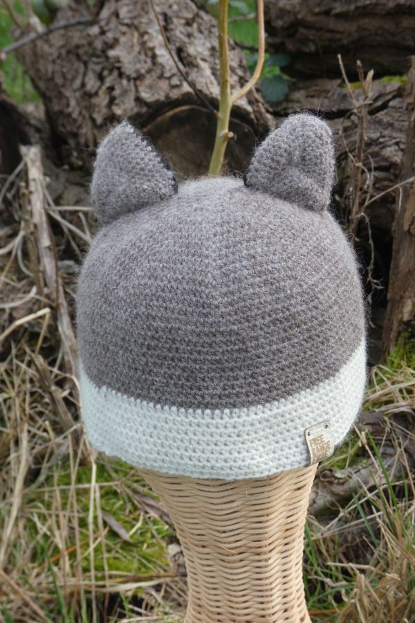 back of a childs hat with fox ears in grey and white made from alpaca yarn