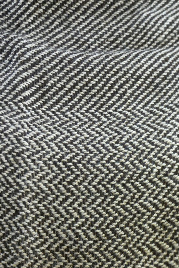 close up of herringbone weave scarf in light and dark alpaca yarn