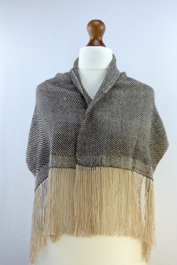 herringbone weave scarf in light and dark alpaca yarn loosly draped over a tailors dummy