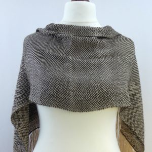 herringbone weave scarf in light and dark alpaca yarn draped over a tailors dummy