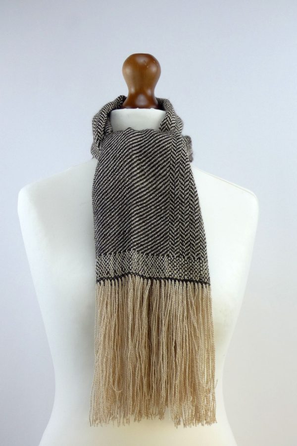 herringbone weave alpaca scarf in light and dark yarn tied around the neck of a tailors dummy