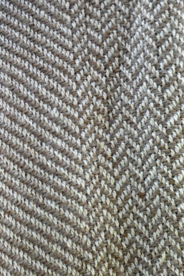 close up of herringbone pattern scarf in cream and fawn