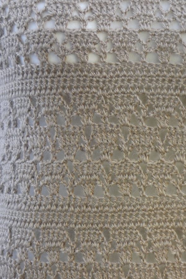 close up of a lacy crochet pattern in fawn alpaca yarn