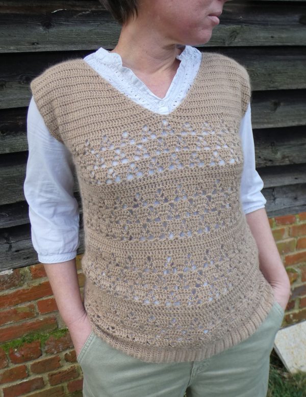 lady wearing a lacy crochet tank top made from a fawn coloured alpaca yarn