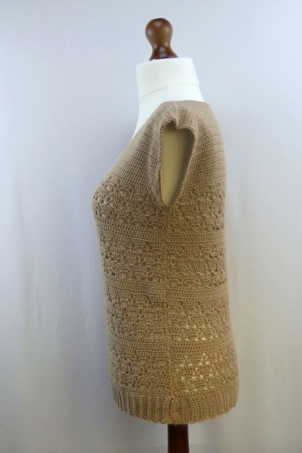 side view of a lacy crochet tank top in fawn alpaca displayed on a dress dummy