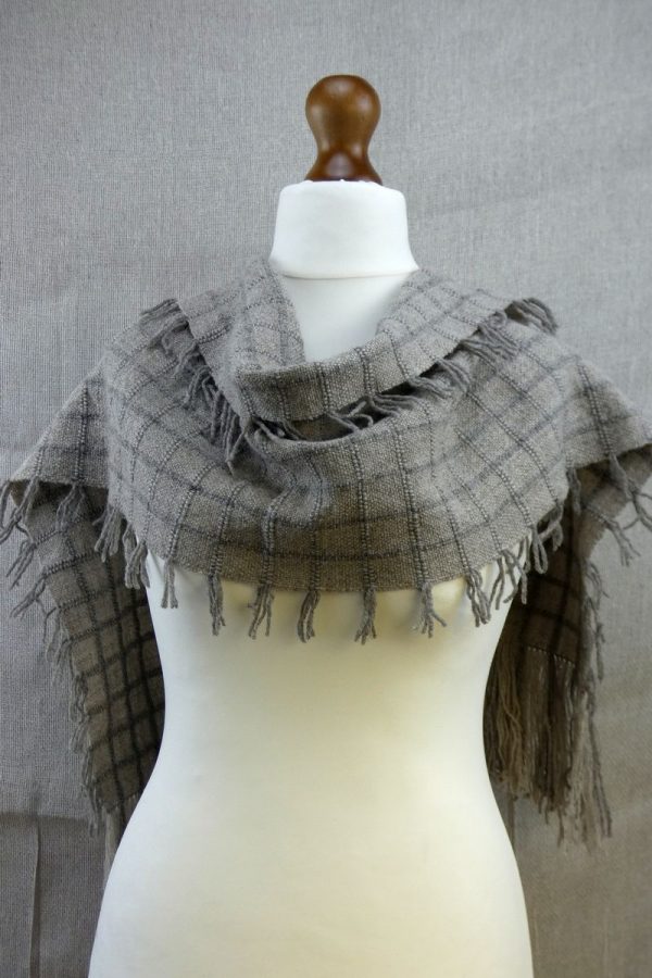 shetland wool scarf with check pattern draped over dress dummy