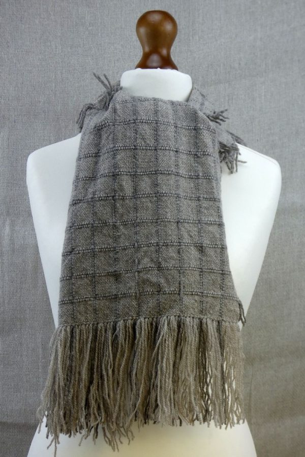 shetland wool scarf with check pattern tied on dress dummy