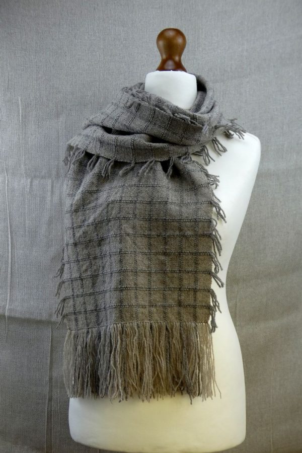 shetland wool scarf with check pattern draped over dress dummy