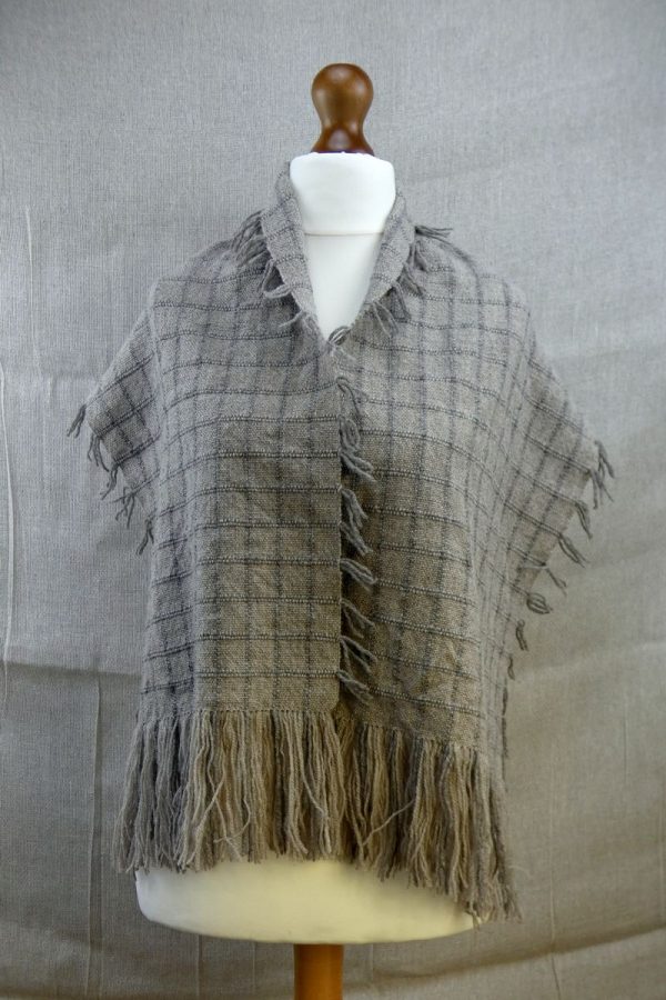 shetland wool scarf with check pattern loosely draped over dress dummy
