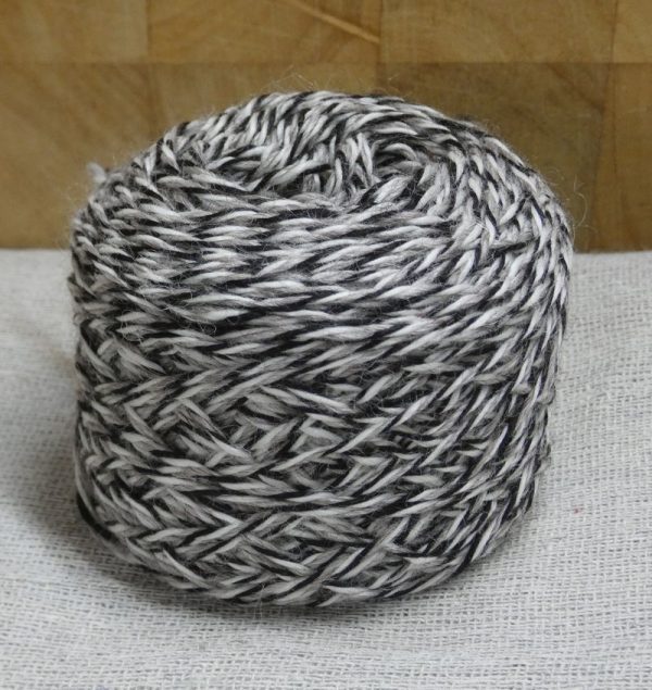 grey white and black barberpole alpaca yarn in a ball