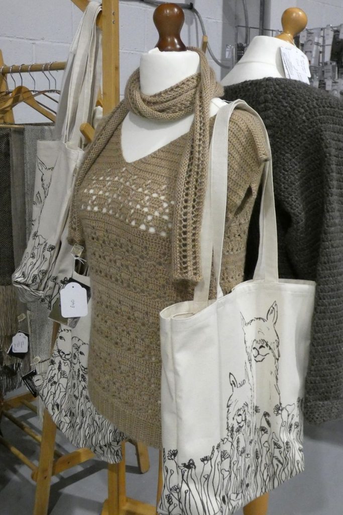 fawn colour crochet top on display dummy with black and white print shopping bag