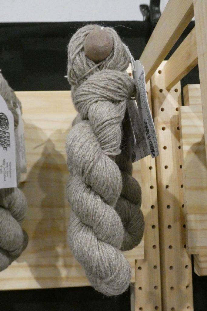 mid grey shetland sheep wool skein on wooden display stand