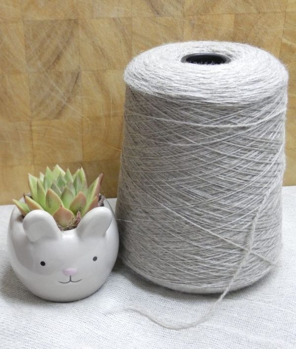 light grey laceweight shetland yarn on cone next to cactus plant in rabbit plant pot