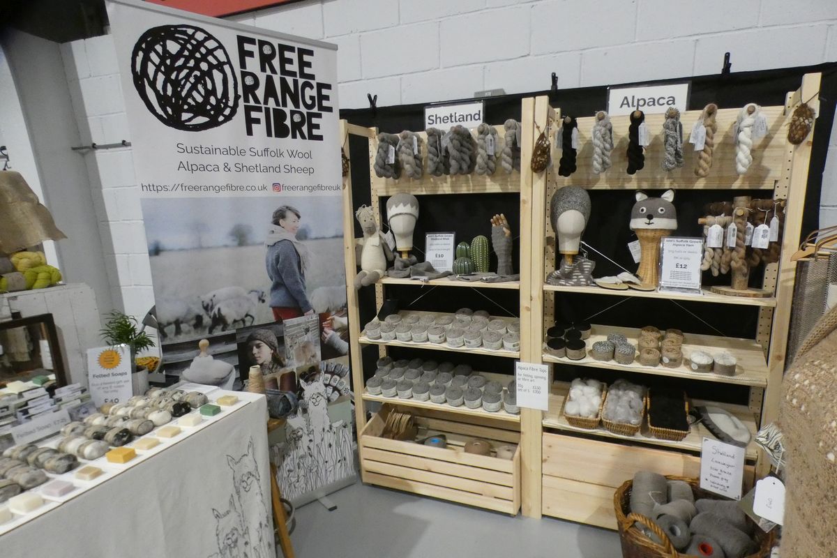 yarn displayed on wooden display stands at the east anglia yarn festival 2024