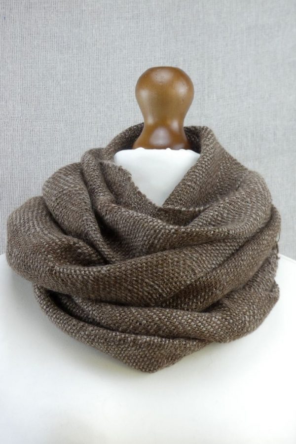 woven suri alpaca scarf with dot detail loosely wrapped around neck on dress dummy