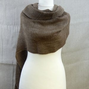 woven suri alpaca scarf with dot detail loosely draped on dress dummy