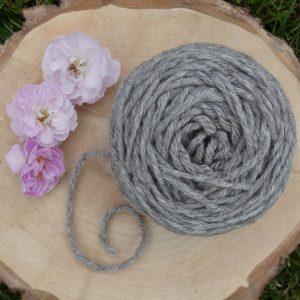 ball of aran weight shetland wool on a wooden platter