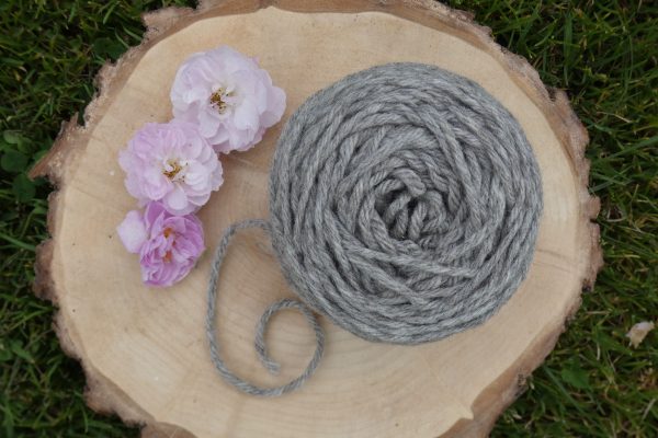 ball of aran weight shetland wool on a wooden platter