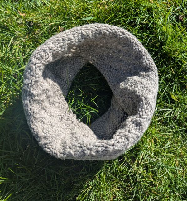 light grey shetland wool snood laying on grass