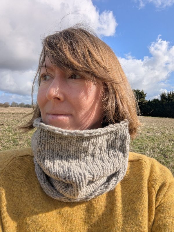 woman wearing a light grey shetland wool snood