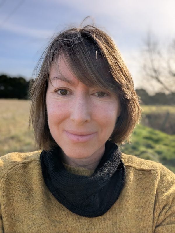 lady in yellow jumper wearing black alpaca snood