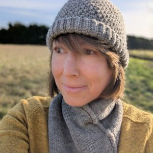 lady wearing shetland hat and snood scarf in mid grey