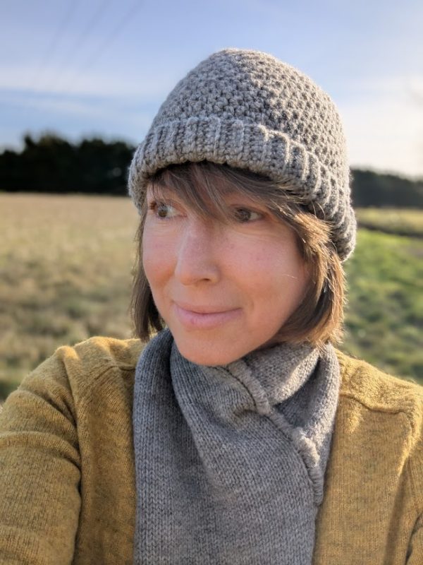 lady wearing shetland hat and snood scarf in mid grey