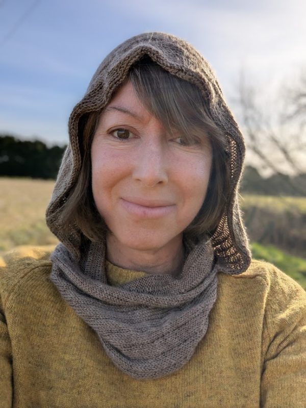 lady in yellow jumper wearing a brown alpaca snood hood