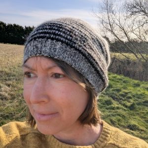 lady wearing striped alpaca beanie in white and black