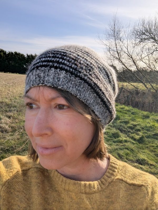 lady wearing striped alpaca beanie in white and black