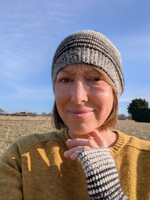 lady wearing striped hat and gloves in alpaca yarn