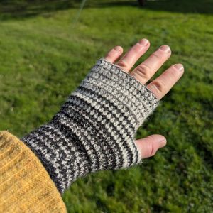 lady wearing a striped wrist warmer in black, white and curlew