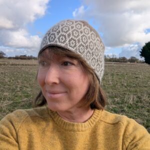 tapestry crochet alpaca hat in grwey and white with a hexagon design