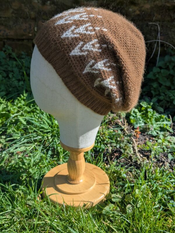 side view of slouchy alpaca beanie in brown and white