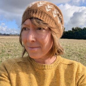 brown and white slouchy beanie with an ears of barley design