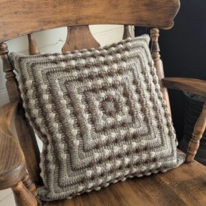 wool crochet cushion in bobble pattern and natural colours