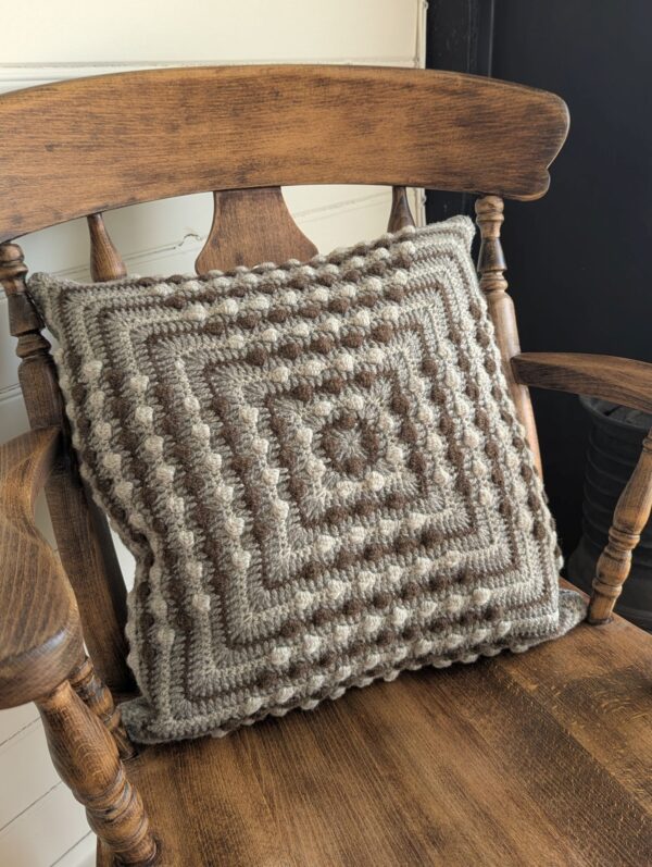wool crochet cushion in bobble pattern and natural colours