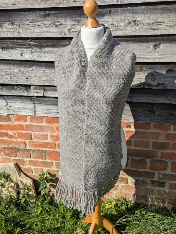 shetland wool woven scarf in grey hanging loose on dress dummy