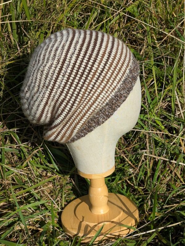 striped alpaca slouch beanie in a mix of stripes on a display head