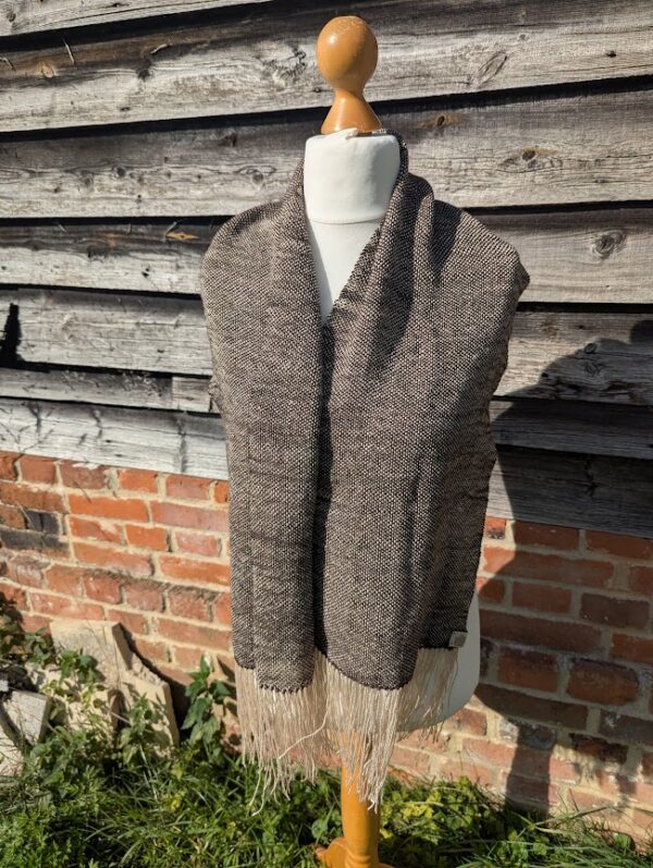 woven suri alpaca scarf in dark brown and cream hanging loose on dress dummy