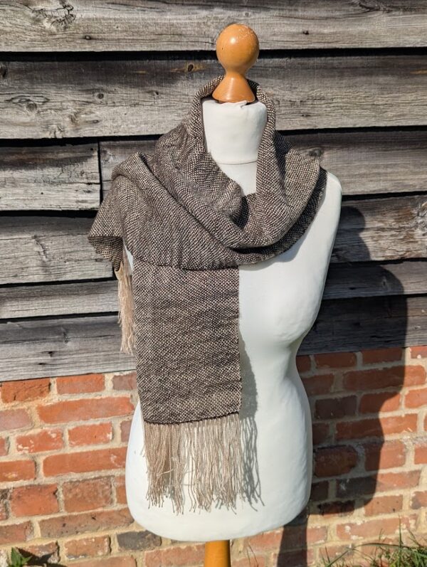 woven alpaca scarf in dark brown and cream wrapped on a dress dummy.